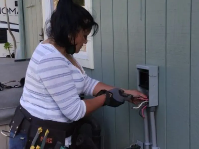 Licensed electrician wiring an exterior subpanel in Rehoboth